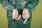 Young man in handcuffs wearing camouflage uniforms.