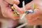 Young man hands peeling a wire using a plier to repair it.