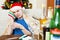 Young man with hangover in Santa hat