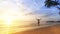 Young man happily jumping on the ocean beach.