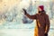 Young Man in hat playing with snow Outdoor Winter