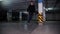 A young man in hat skateboarding inside the parking lot