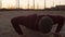 Young man having evening training outdoor. Urban sunset background. Fitness and sport.