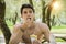 Young Man Having Fast Food Lunch at Picnic Table