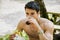 Young Man Having Fast Food Lunch at Picnic Table