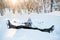 Young man having fun in snow outdoors in winter, lying in snow.