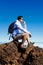 Young Man Having a Rest in a High Peak Over Clouds in Teide Mountain