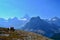 Young man is having a rest, laying on the ground high in the mountains