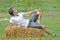 Young man on hay bale