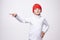 Young man with a headband points with his index finger at the space for text. photo session in the Studio on a white background