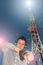 Young Man with Helmets and Telecommunications Antenna between