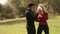 Young man helping woman with mask