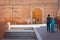 A young man helps an older woman walk towards the Ksibet Nhas Port of the medina in the city of Marrakech. Morocco October 2019