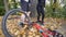 A young man helps a woman who has fallen from a bicycle