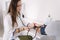 Young man with high blood pressure. Female doctor using sphygmomanometer with stethoscope checking blood pressure to a