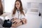 Young man with high blood pressure. Female doctor using sphygmomanometer with stethoscope checking blood pressure to a