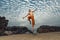 Young man high jumping on beach