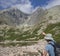 Young man hiker looking and point to mountain Peak Lomnicky stit 2 634 m at Summer, the highest mountain peaks in the