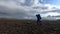 Young man hikes through rough Iceland terrain during strong wind up to 30 miters per second on the Fimmvorduhals hiking
