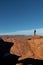 Young man hiking in arid Arizona with blue sky in the background