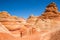 Young man hiking through Coyote Buttes and the famous Wave feature of Arizona