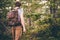 Young Man hiking in forest with backpack Travel Lifestyle