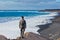 Young man hiking and looking up to the sea