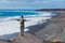 Young man hiking and looking up to the sea