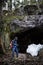 Young man hiking in scandinavia landscape. Rocks hidden in the f