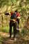 Young man hiking in tropical jungle with backpack. Male hiker with rucksack walking along forest trail.