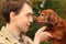 Young man and his adorable dachshund closeup