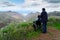 Young man and his wife in wheelchair travelling together in mountains