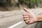 Young man hitchhiking on a secondary road