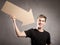 Young man holding arrow cardboard