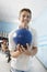 Young Man Holding Ball At Bowling Alley