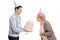 Young man holding a birthday cake with a mature woman blowing th