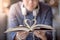 Young man holding book with heart shape page folded