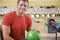 Young man holding a bowling ball in a bowling alle