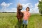 Young man holding his beautiful horse by a bridle