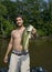 Young man holding large mouth bass