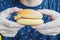 Young man holding in male hands fast food burger, american unhealthy calories meal on background,