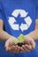 Young Man Holding Seedling in his Hands, Recycling Symbol, Close Up