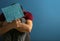 Young man holding sheet of paper with words PANIC ATTACK on color background