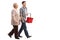 Young man holding shopping basket and walking with mature woman