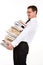 Young man holding stack of books