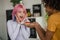 Young man holding a straberry cake with a candle, his girlgriend happy