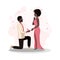 Young man holds a diamond ring in his hand and proposes marriage to a young woman