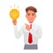 Young man holds a light bulb in his hand and points at it. Portrait of a happy student. Smart white guy with an idea of how to