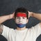 Young man with Holland flag painted on his face