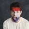 Young man with Holland flag painted on his face